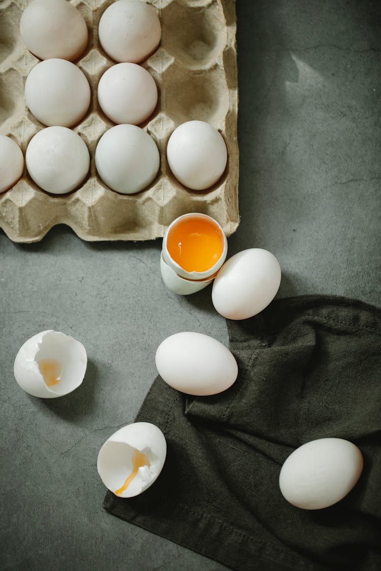 Raw Cracked Eggs Placed In Box On Table