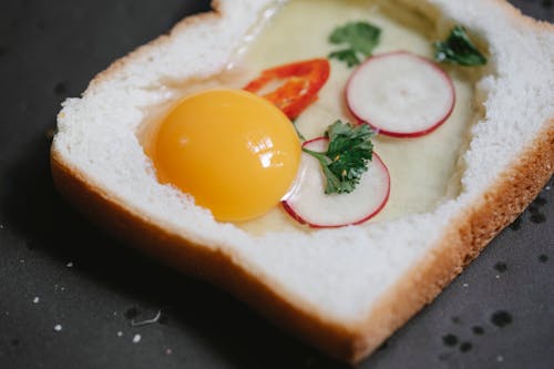 Free Delicious raw egg toast with reddish placed on pan Stock Photo