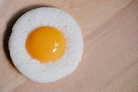 Egg yolk placed in round white bread crumb