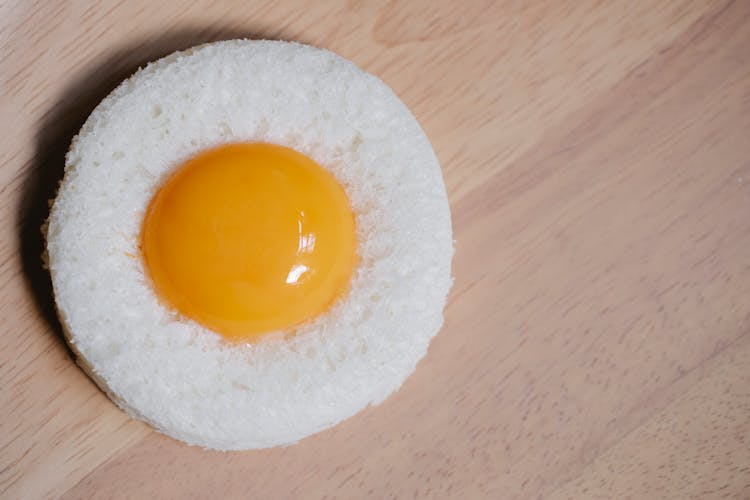 Egg Yolk Placed In Round White Bread Crumb