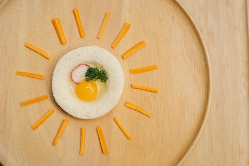 Free Appetizing raw egg toast decorated with cheese sticks Stock Photo