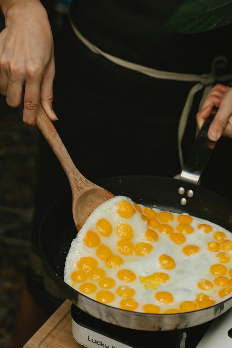 Crop Faceless Chef Frying Quail Eggs