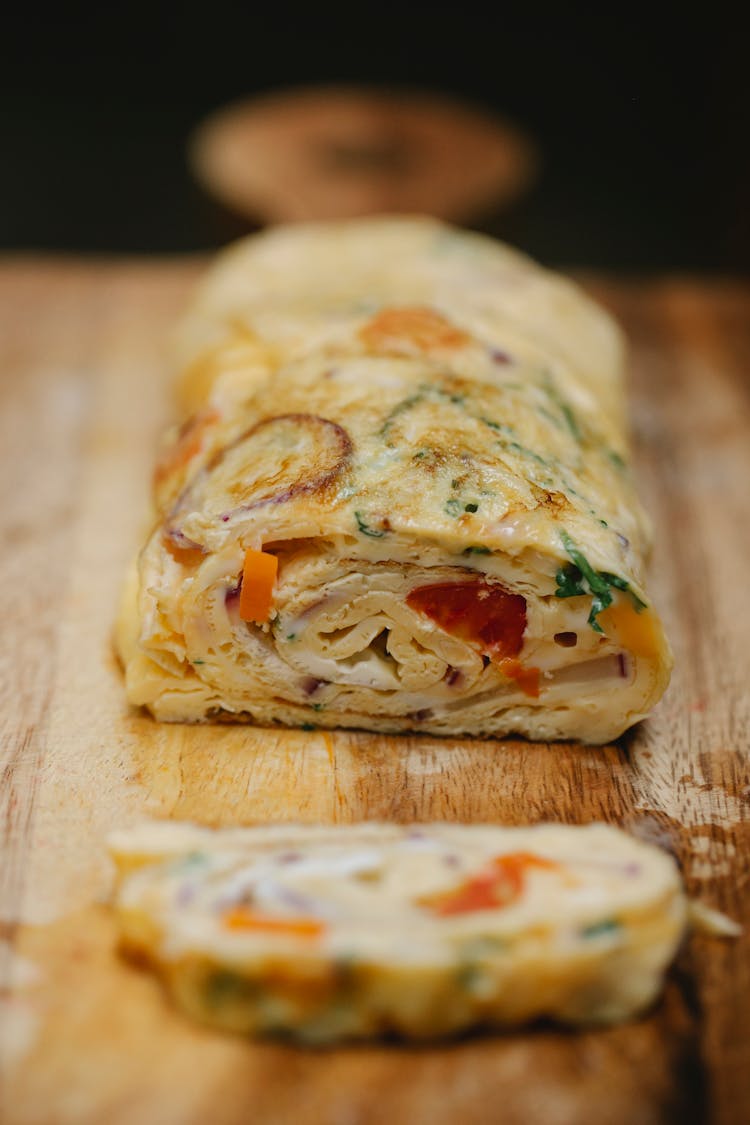 Yummy Vegetable Egg Roll Cut On Wooden Board