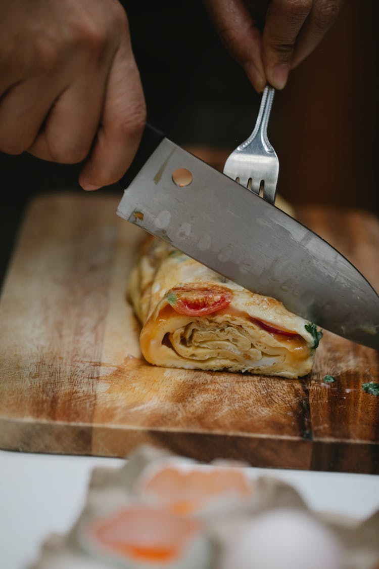 Crop Unrecognizable Chef Cutting Tasty Omelette Roll