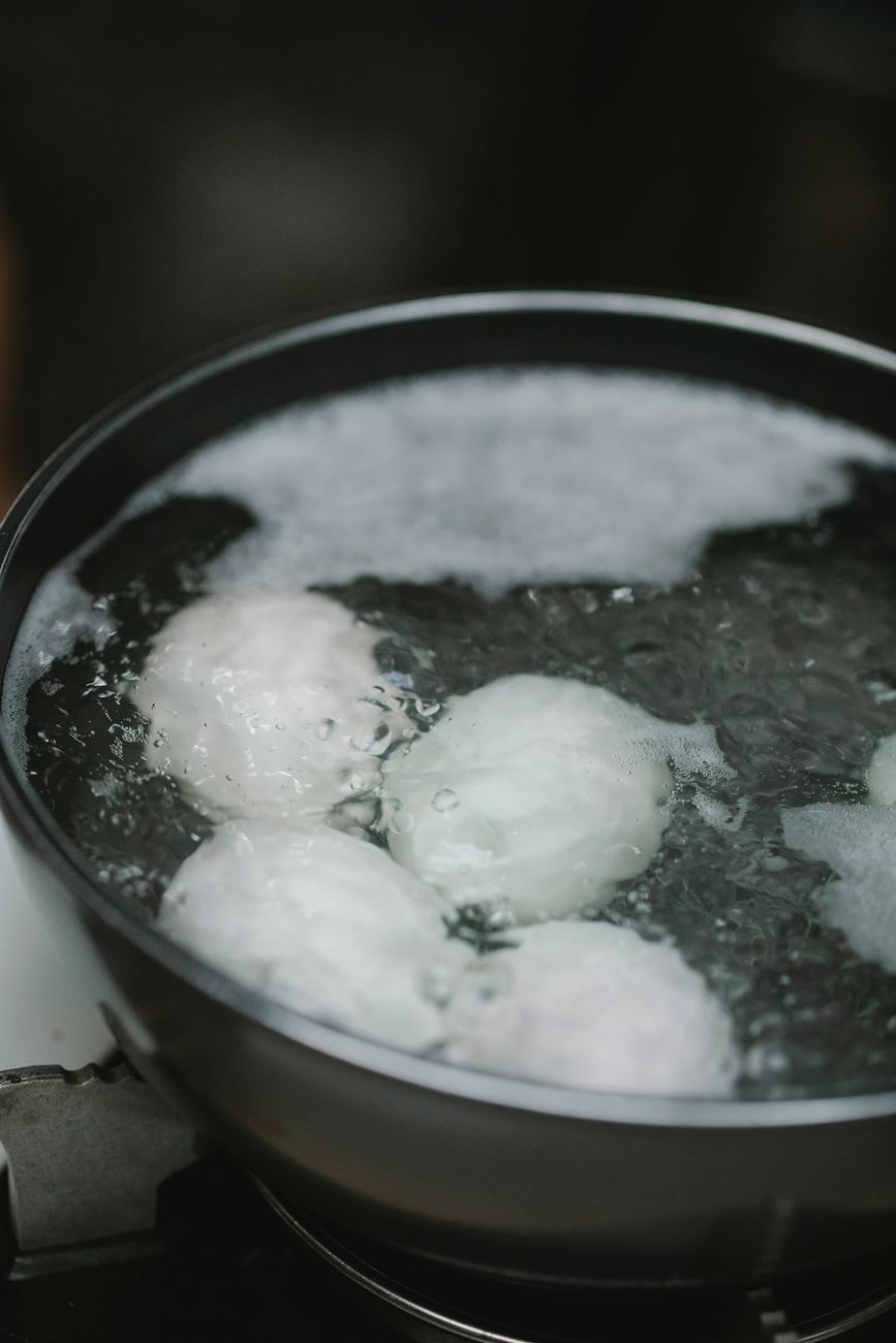 Boiled eggs cooling in a bowl in the kitchen