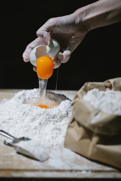 Adding of Egg on a Heap Flour 