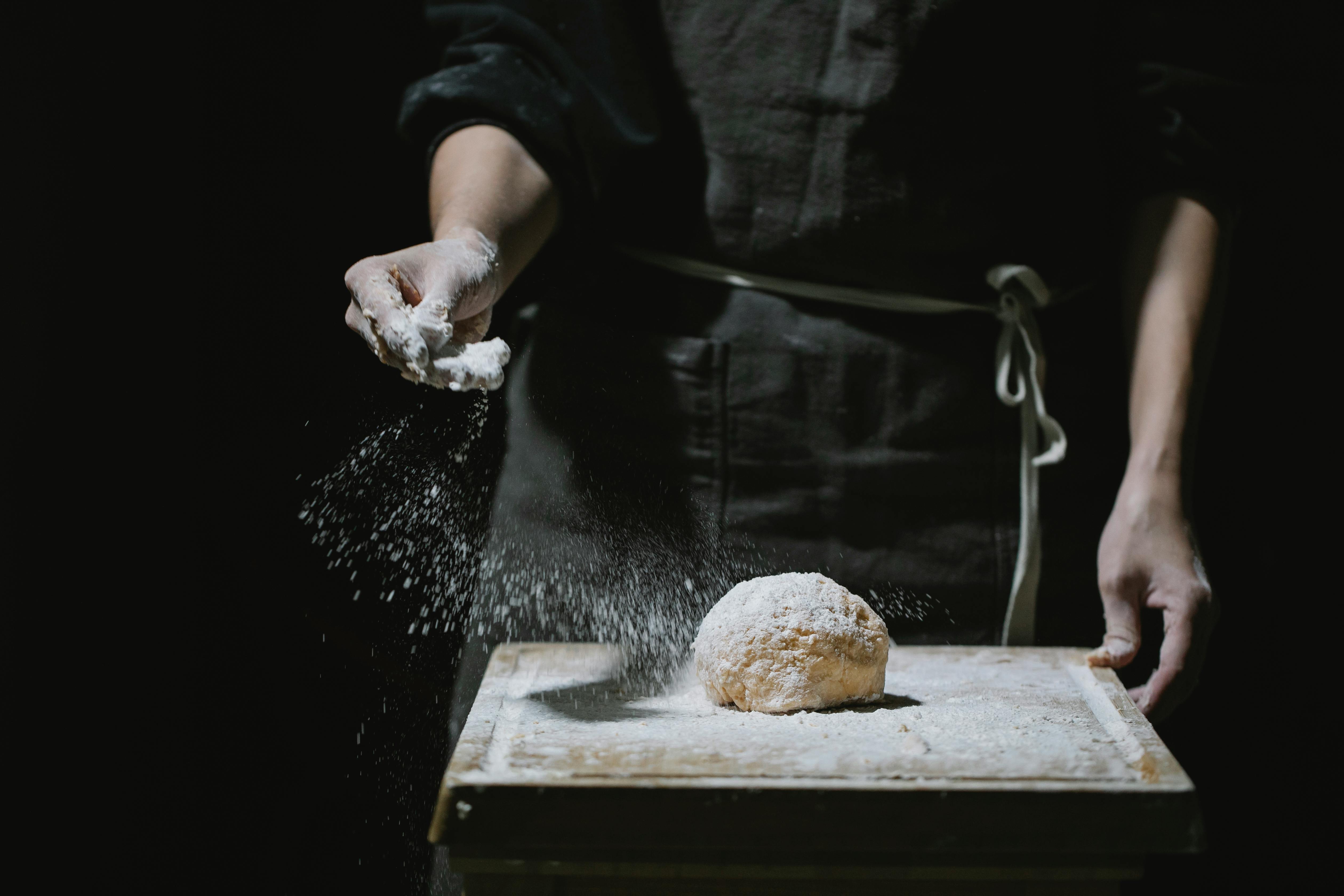 cook sprinkling flour on dough for pastry