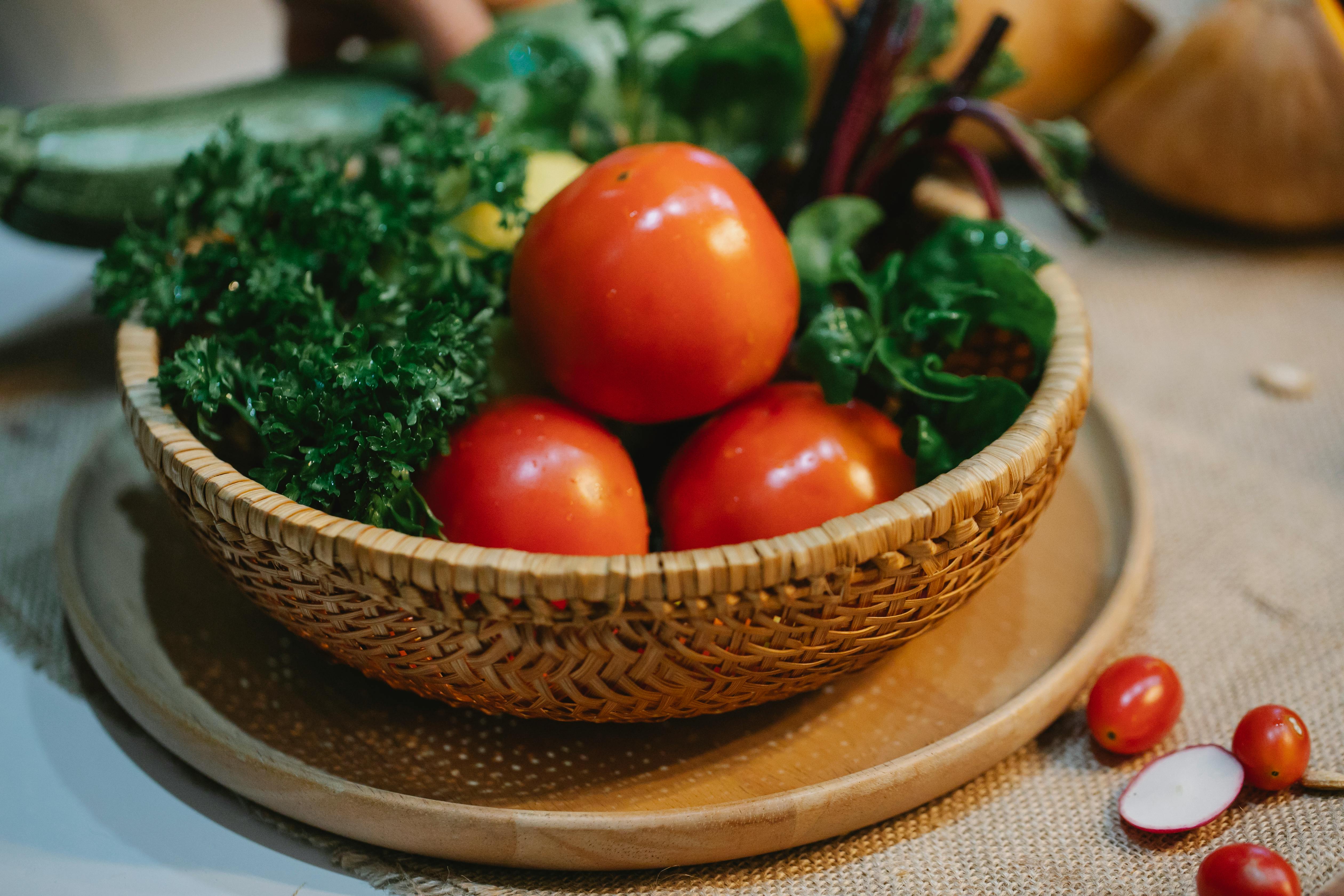 wicker bowl of clean wet tomatoes and parsley