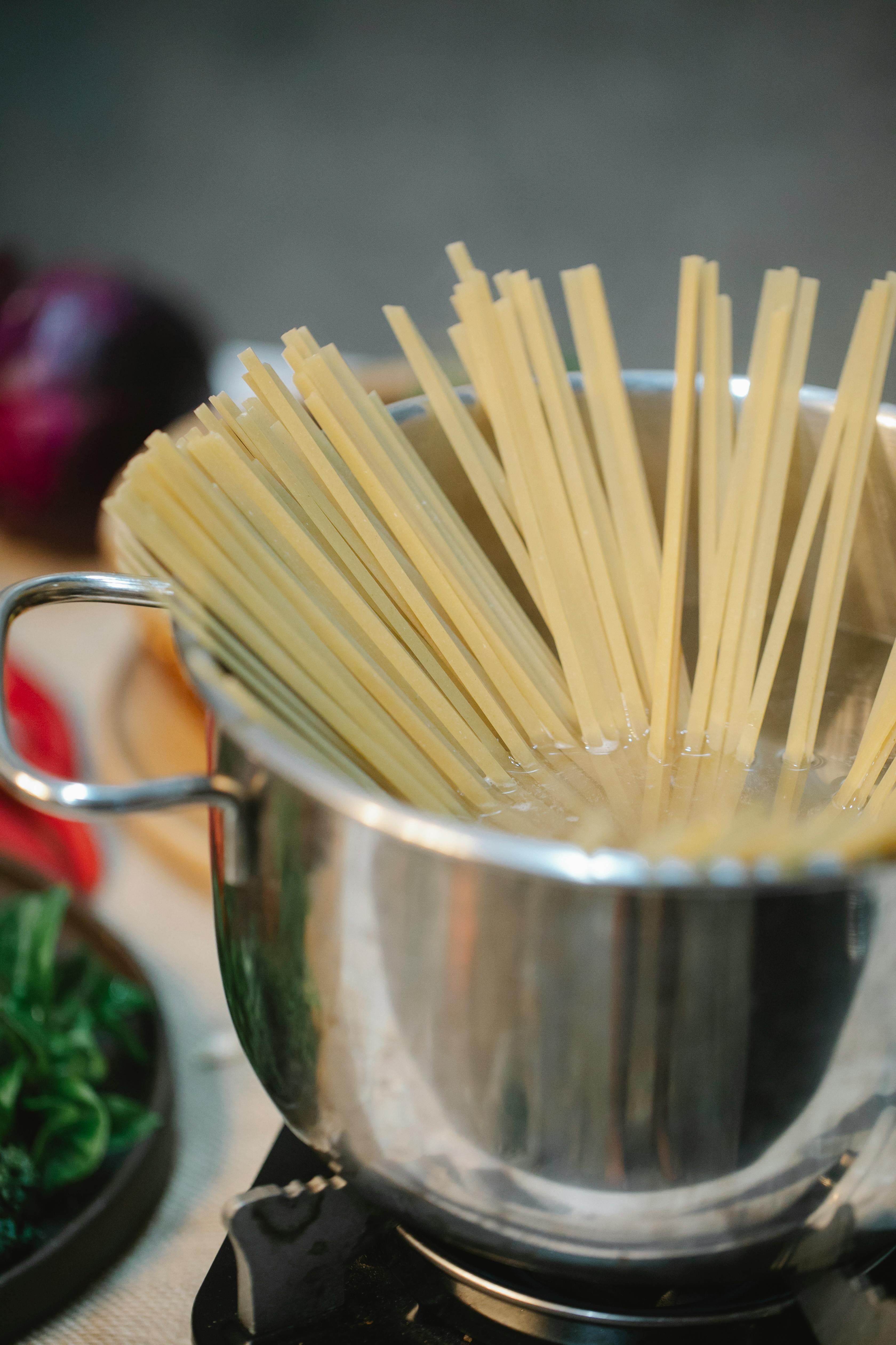 process of cooking spaghetti in pan