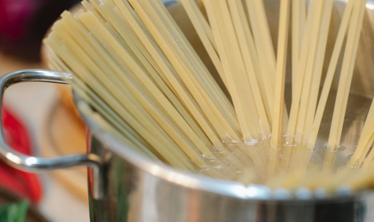 Steam rising from a stainless steel pot of boiling water on a countertop burner