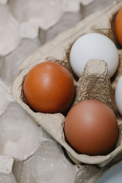 Carton container with eggs on table