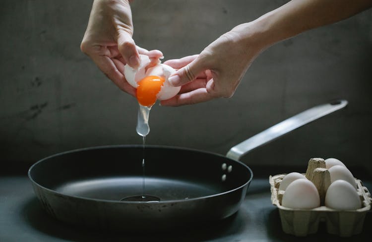 Woman Cooking Eggs On Pan