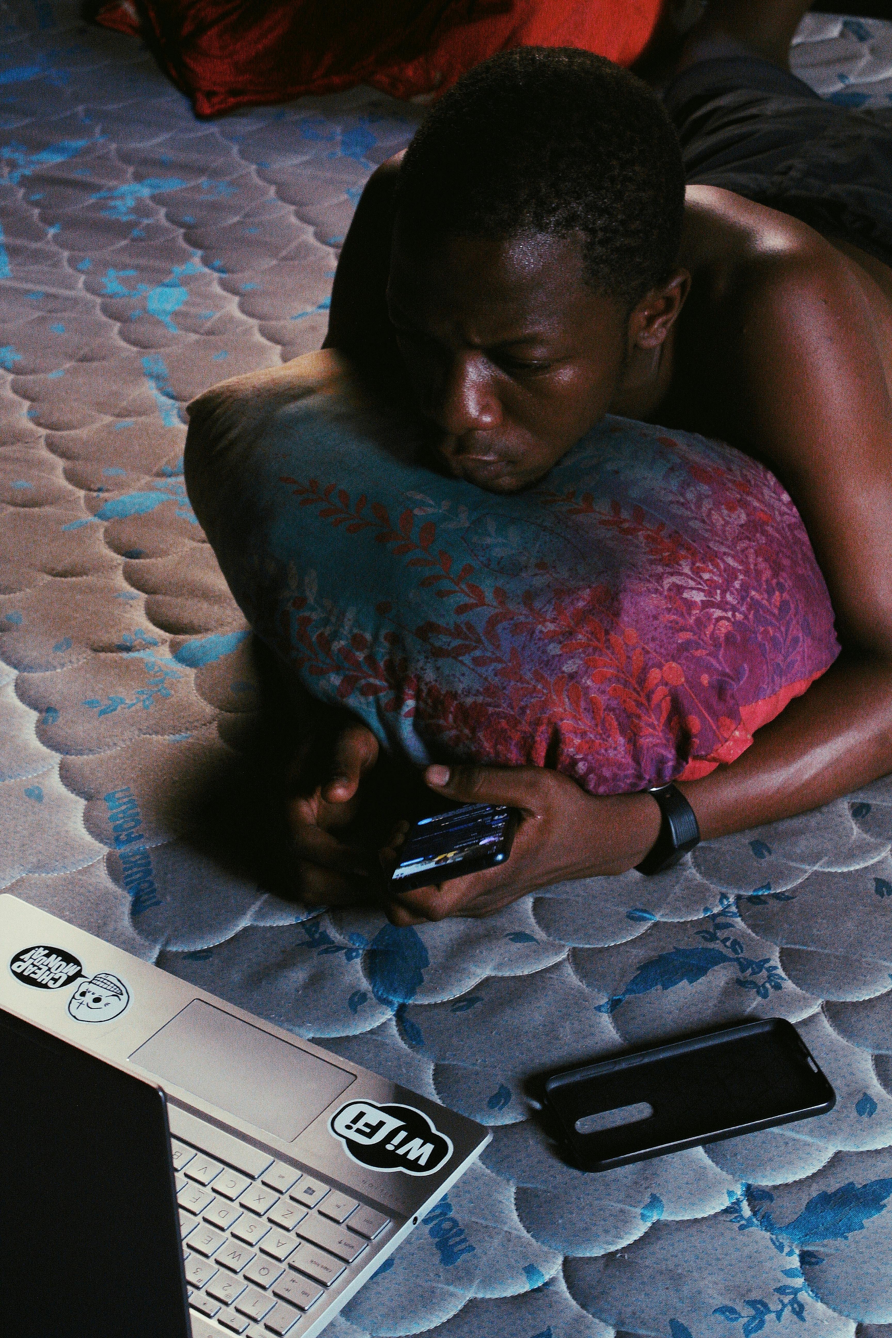 serious black man with laptop and smartphone