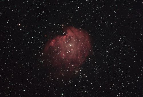 Free A mesmerizing capture of a vibrant nebula surrounded by a starry sky in deep space. Stock Photo