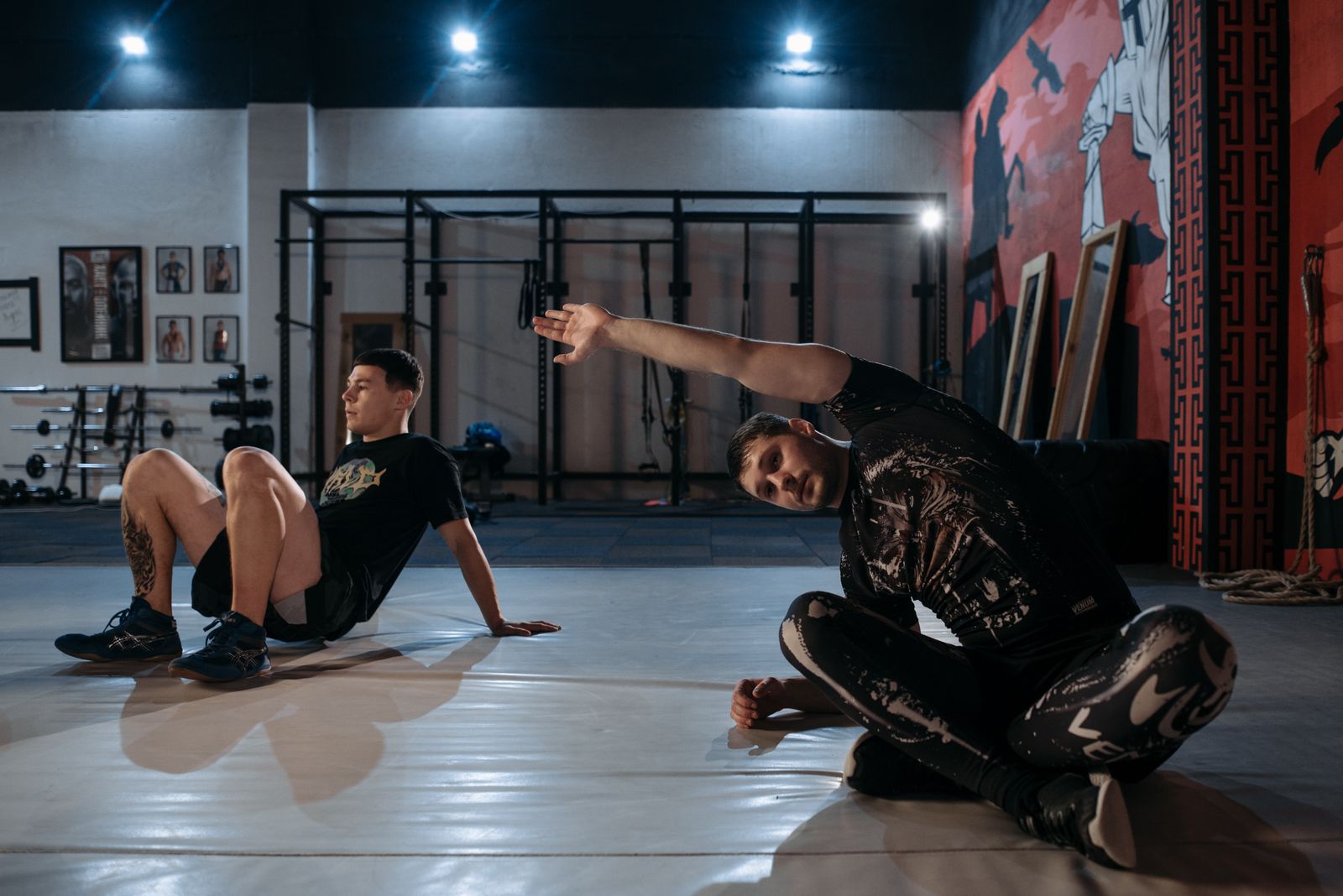Two training partners warming up together on a gym floor — photo by Pavel Danilyuk on Pexels