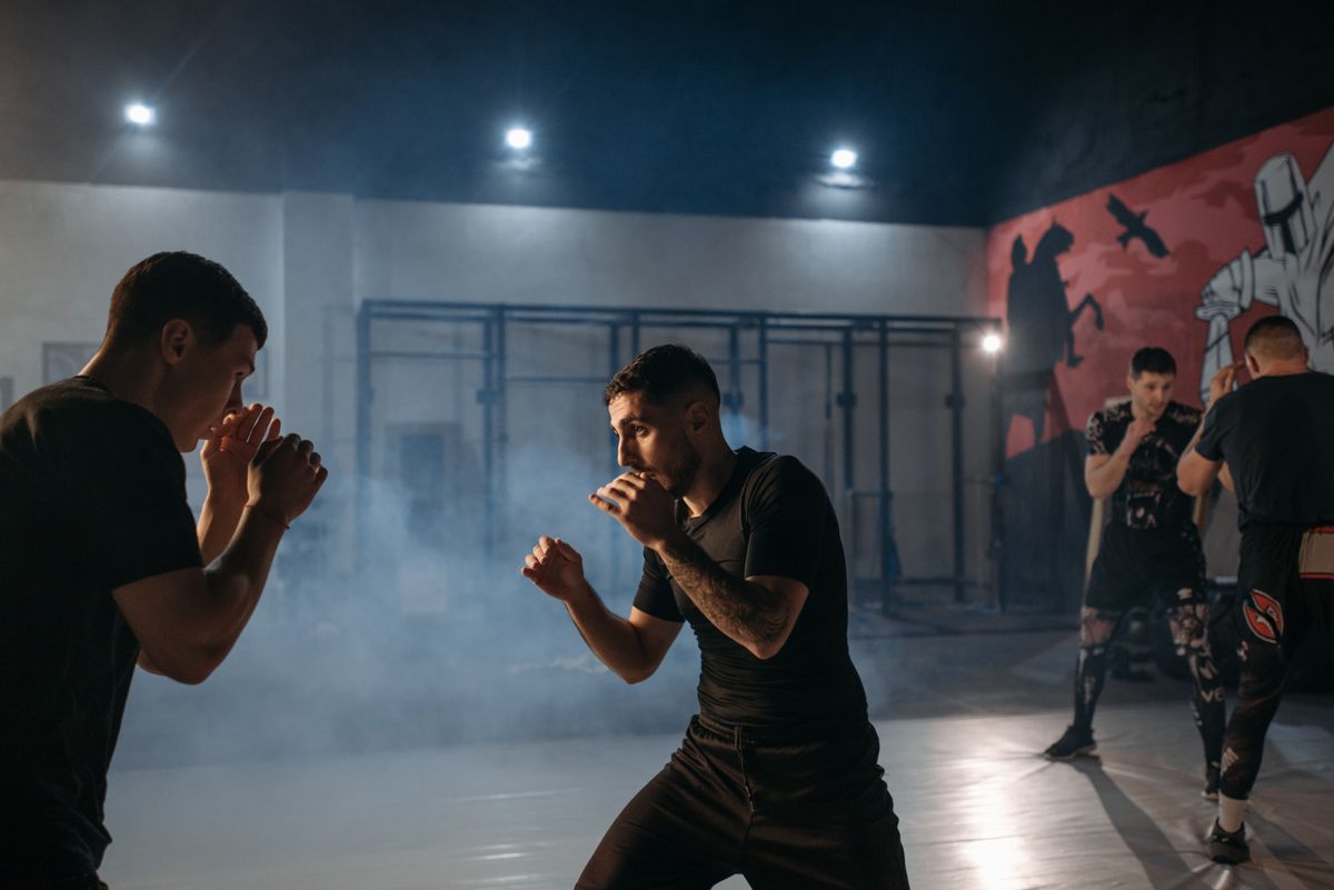 Two MMA fighters sparring in a cage