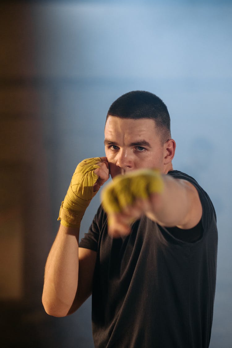 A Man In Black Shirt Showing A Fighting Stance