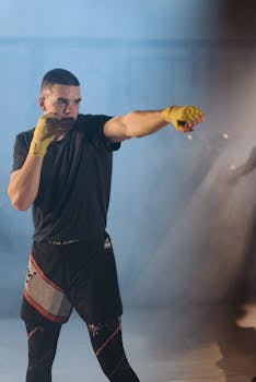 Male boxer training with intense focus, showcasing strength and technique indoors.