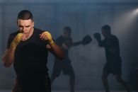 Man in Black Crew Neck T-Shirt Wearing Yellow Bandage on his Hands