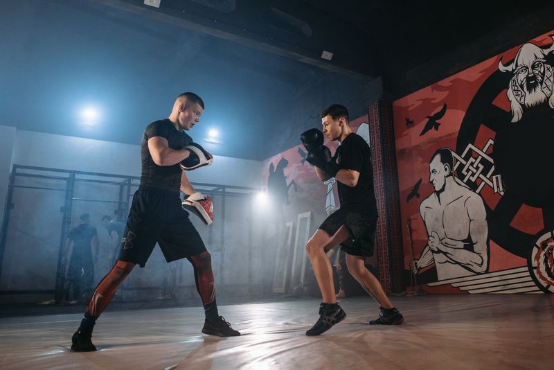 Fighters drilling punches on focus mitts in a gym