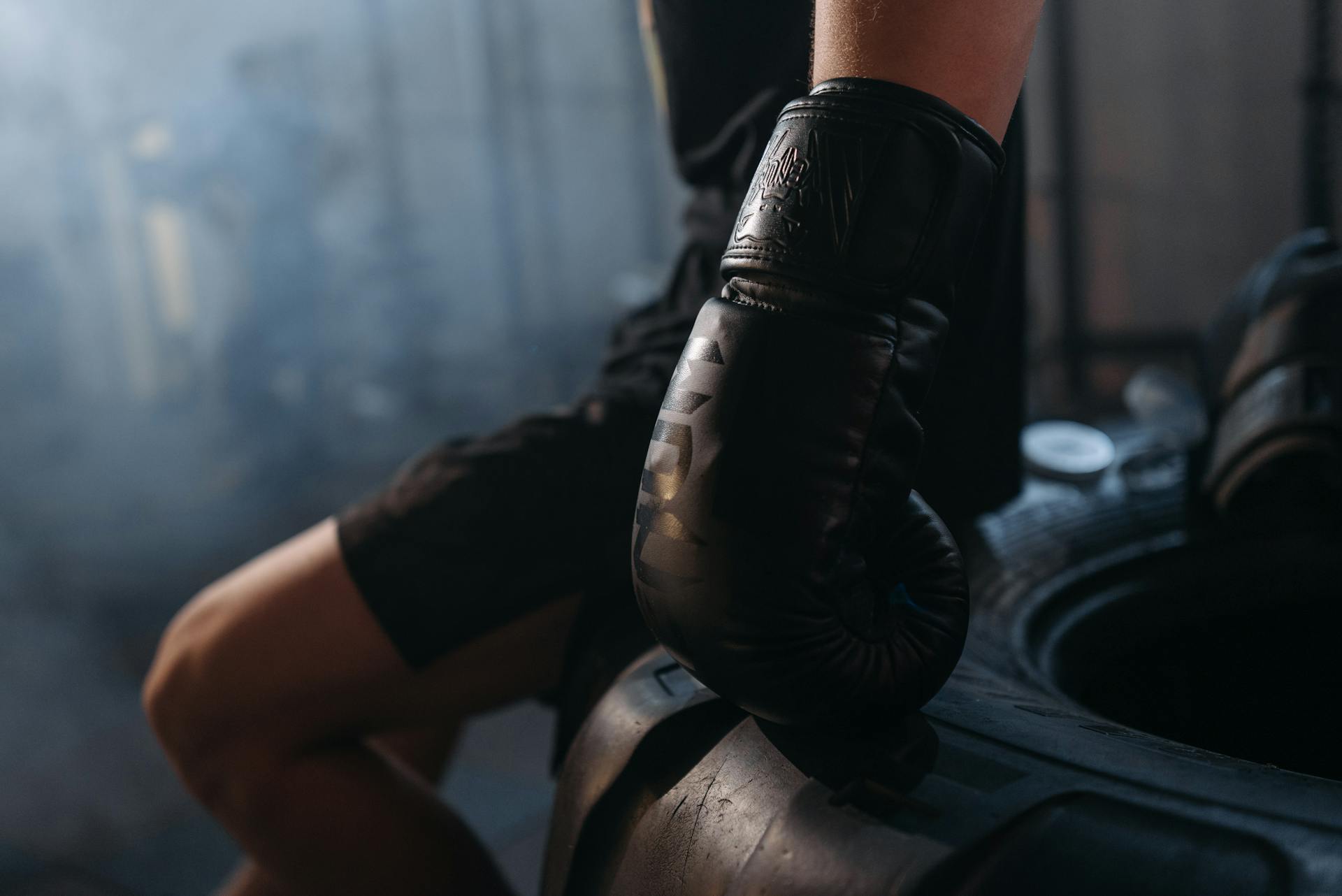 A Boxer Wearing Black Boxing Gloves