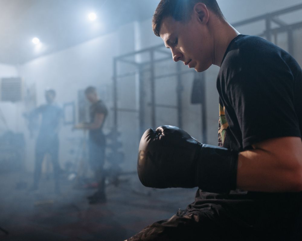 Boxer preparing in a dark training gym