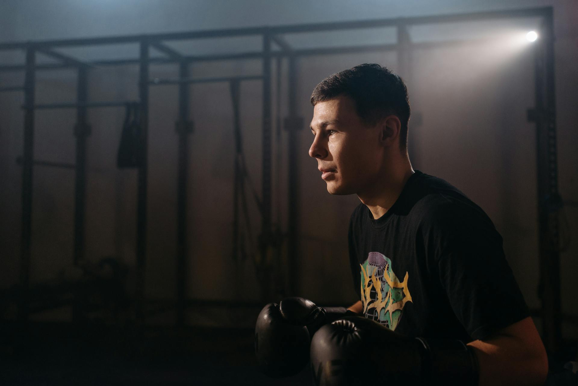 A Man in Black Shirt Wearing Boxing Gloves