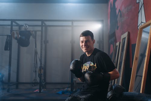 A Smiling Man Wearing  Boxing Gloves