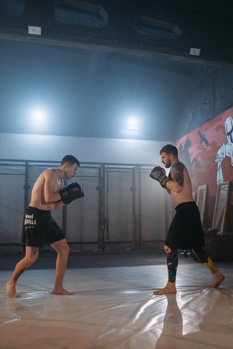 Men Sparring Inside The Gym