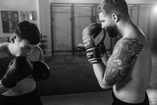 Man in Black and White Nike Boxing Gloves