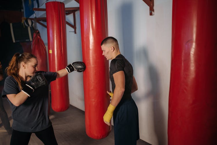 Woman Hitting The Red Punching Bag