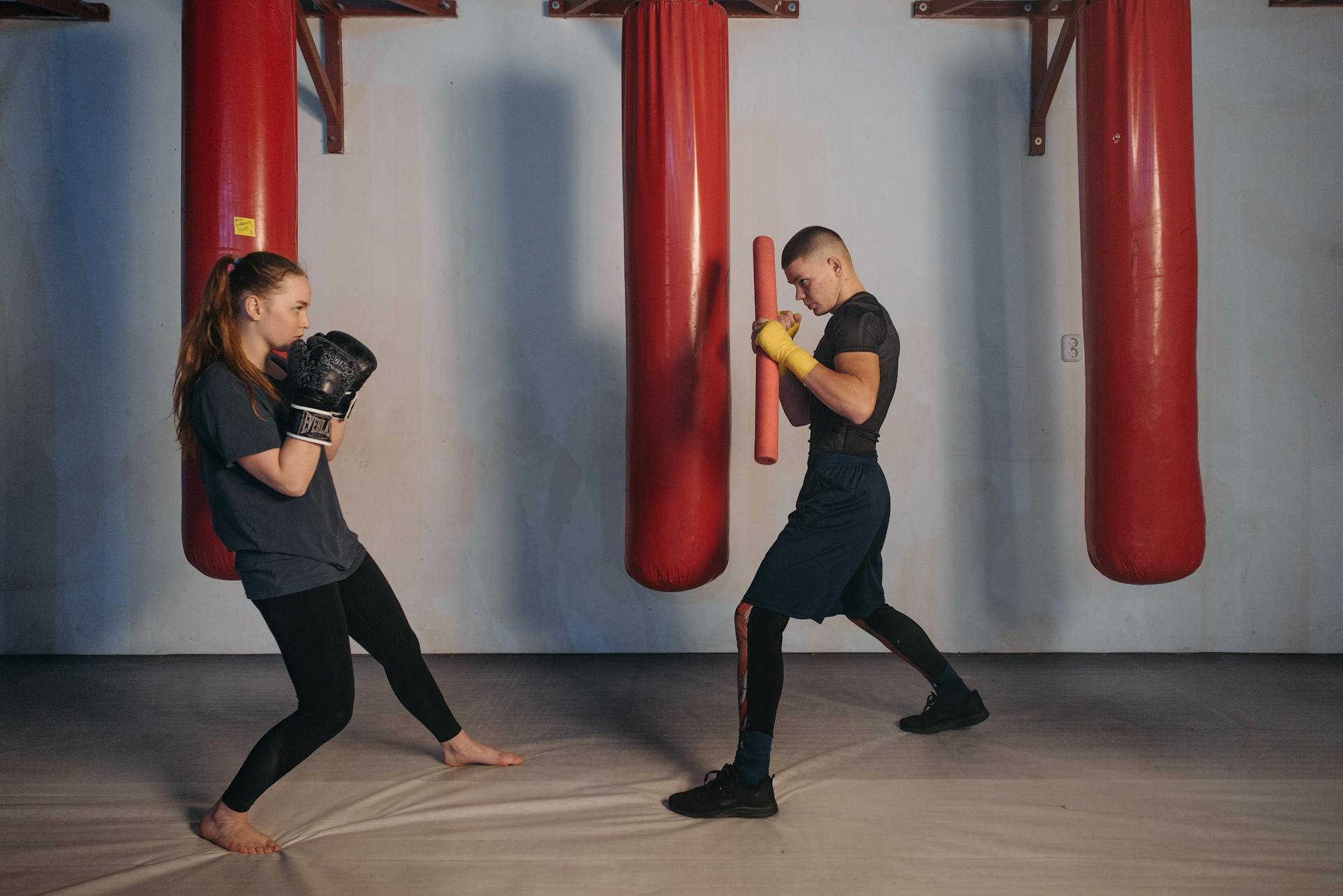 Woman Training Boxing with a Man