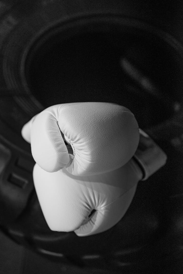 White Boxing Gloves On Black Tire