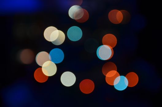 Vibrant abstract bokeh lights with colorful circles on a dark background.