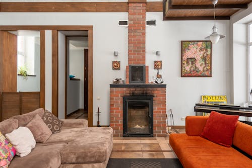 Free Brick fireplace near couches in apartment Stock Photo