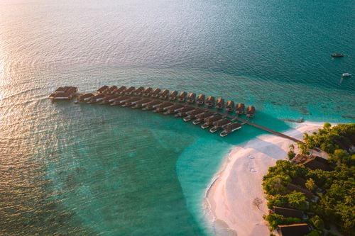 Free Stunning aerial shot of Kudafushi Island Resort with turquoise waters and sandy beach. Stock Photo