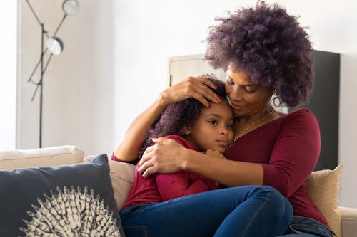 Free A Woman Holding her Daughter Close Stock Photo