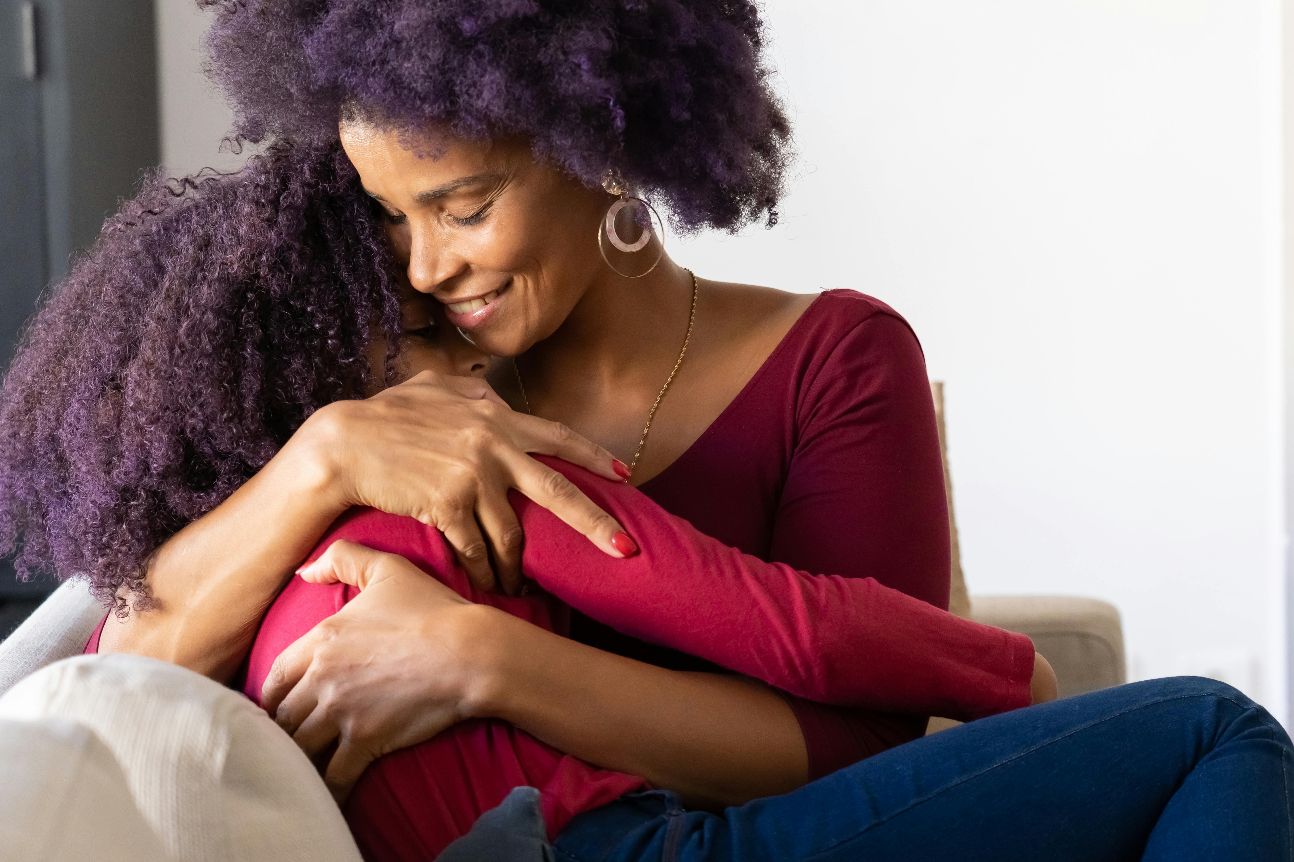 a woman hugging her daughter