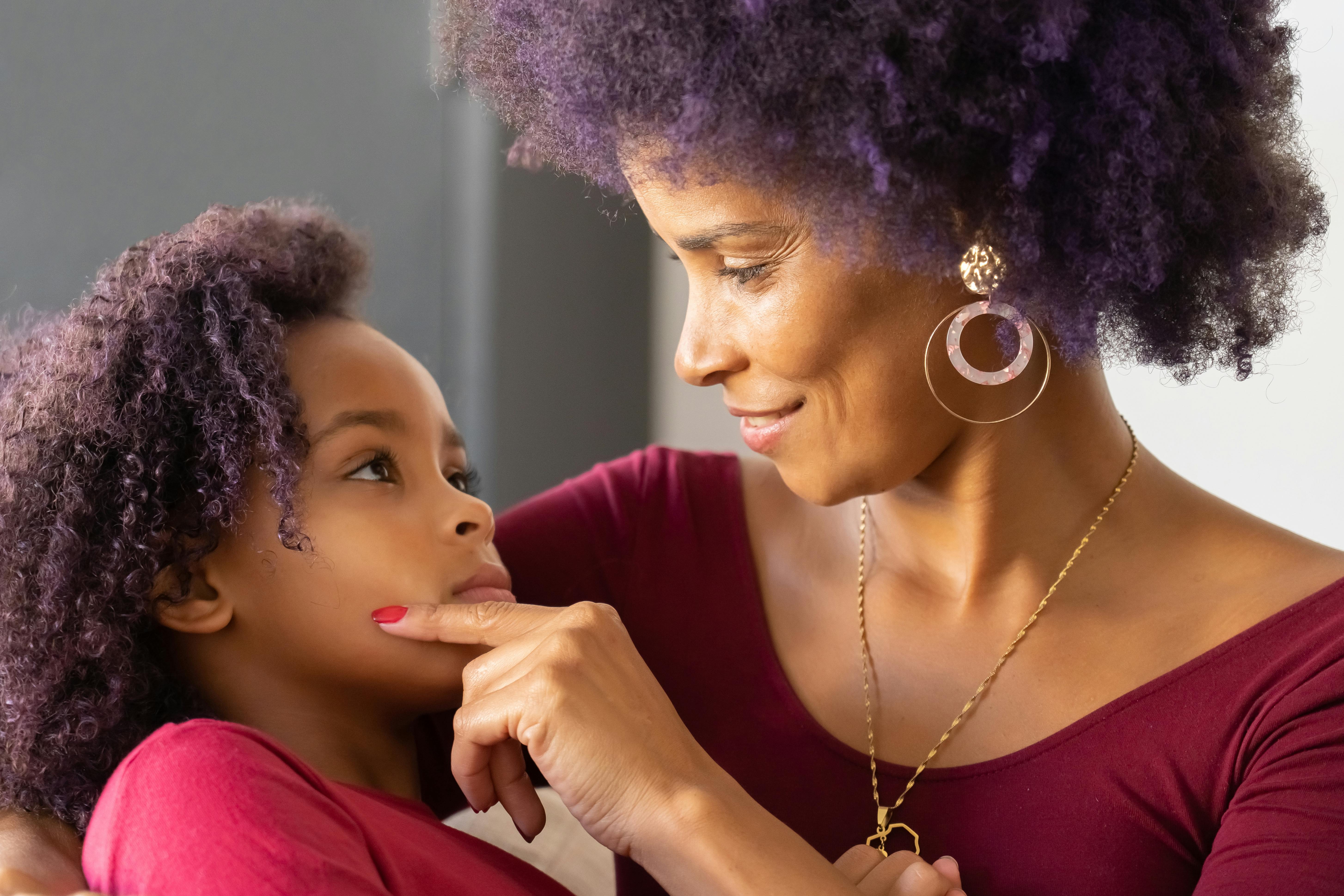 smiling woman touching her daughter s face