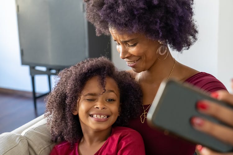 A Mother Looking At Her Daughter Winking