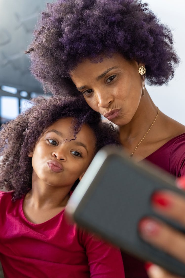 A Mother And Daughter Doing Selfie