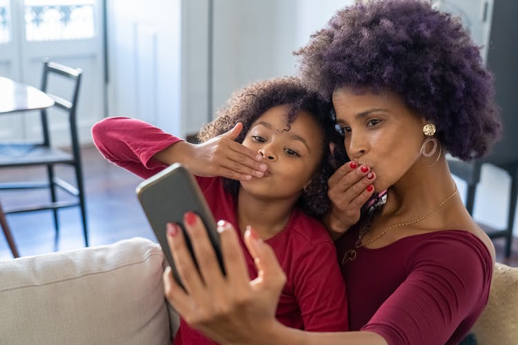 A Mother And Daughter Doing Selfie