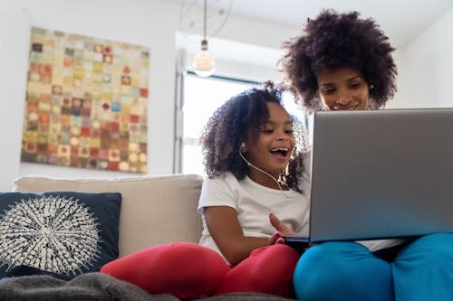 Free A Mother and Daughter Using a Laptop Together Stock Photo