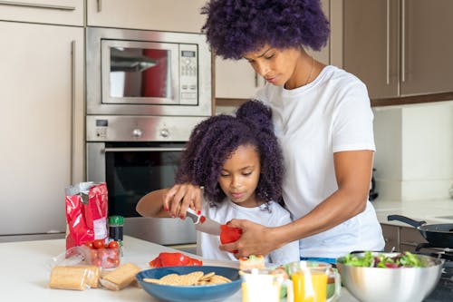 A Woman Preparing Food with her Daughter