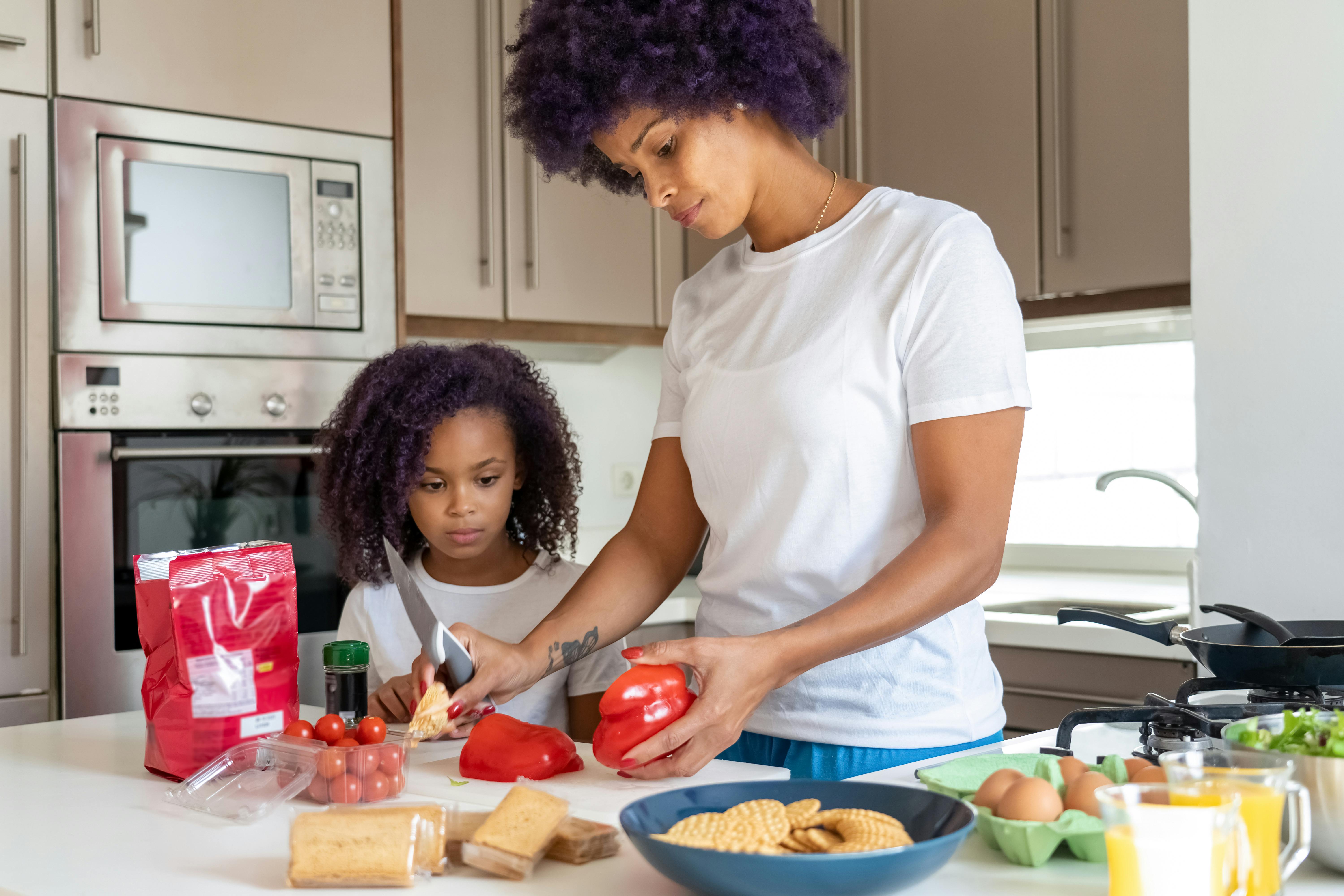 a woman preparing food with her daughter