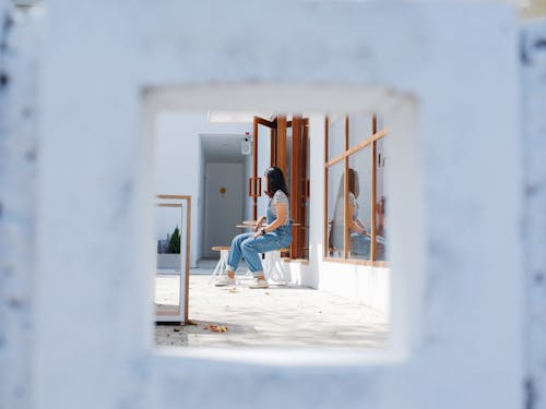 Person Sitting on a Wooden Chair