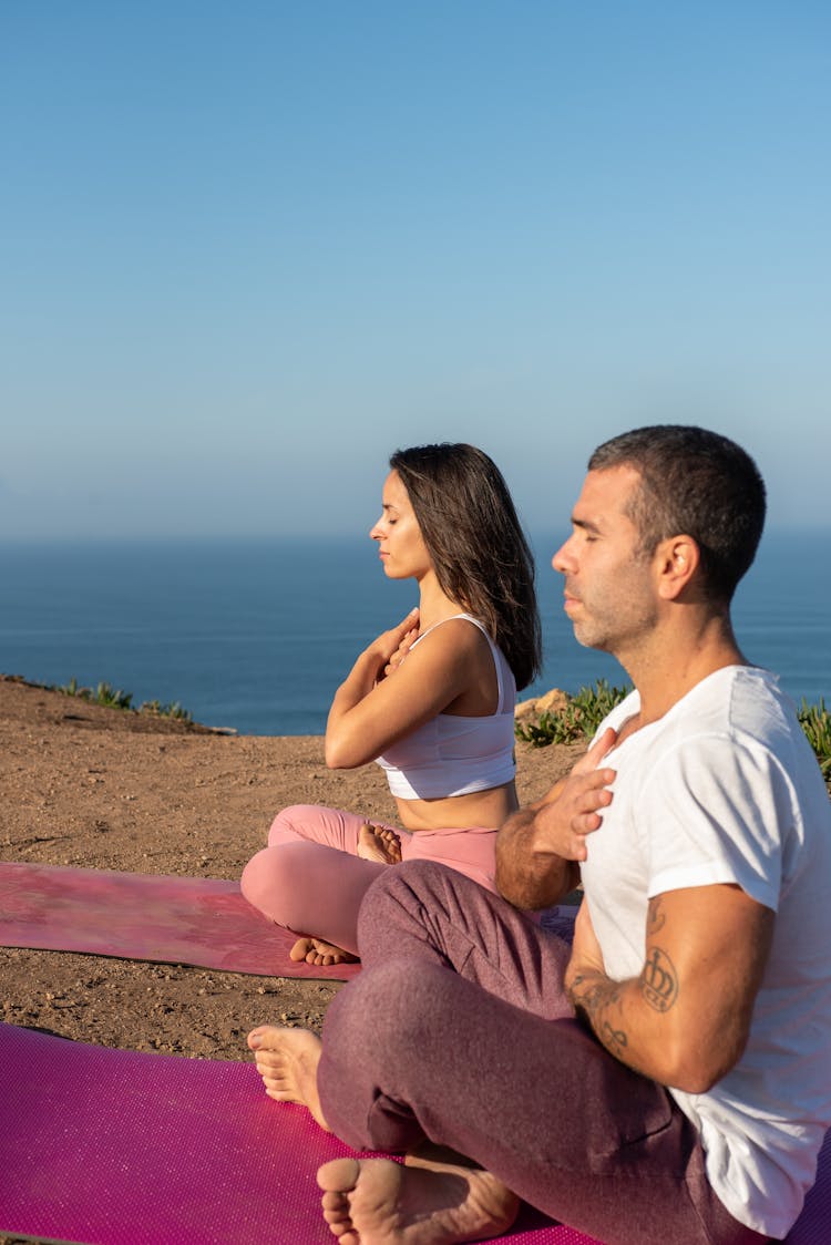 Man And Woman Meditating In The Morning