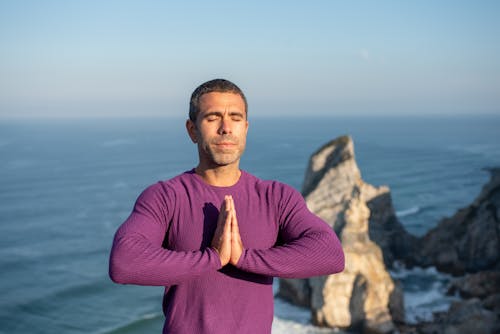 Man Meditating with his Hands Together