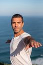 Man in White Crew Neck T-Shirt Doing Warrior Pose