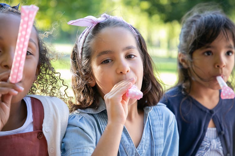 Kids Playing With A Whistle Toy